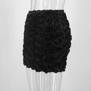 Detailed view of the 3D rose flower texture on a black bodycon mini skirt