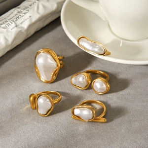 Baroque pearl ring set in gold stainless steel finish displayed on a textured background