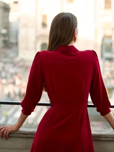 Elegant wine red wrap dress with puff sleeves and waist tie, back view outdoors