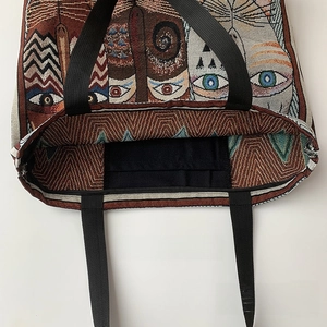 Detail of jacquard tote bag showing interior lining and built-in mobile phone pocket