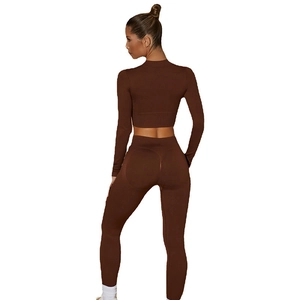 Two-piece chocolate brown ribbed yoga set with long sleeve crop top and high waist leggings