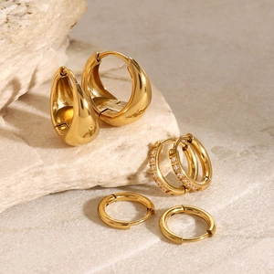 Three pairs of gold stainless steel hoop earrings with polished and rhinestone details