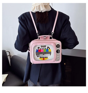 Detail of creative pink TV-shaped backpack with NO SIGNAL screen and retro heart dials