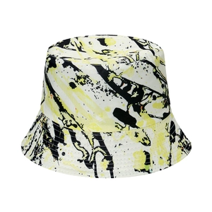 Street style graffiti bucket hat featuring trendy yellow and black ink splash patterns