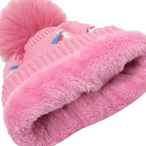 Close-up of pink knit baby hat with thick fleece lining and colorful unicorn embroidery