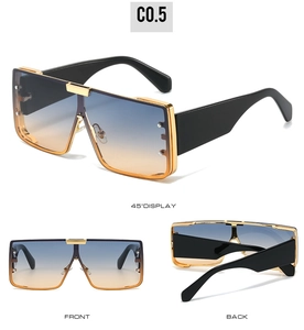 Detail view of square sunglasses with gradient blue-orange lenses and gold metal trim