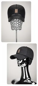 Close-up of black quilted baseball cap with ear flaps and diamond stitch pattern
