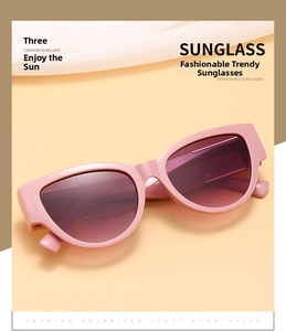 Close-up of polarized purple gradient lenses on pink oval cat eye sunglasses