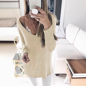 Women's V-neck long sleeve knit sweater in cream yellow paired with white pants