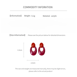 Detail view of red acrylic oval earrings showing size dimensions and weight info