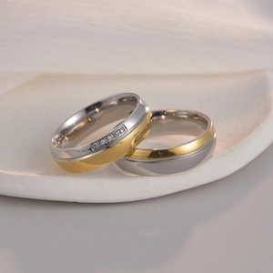 Two-tone titanium steel couple rings with gold accents and sparkling cubic zirconia stones