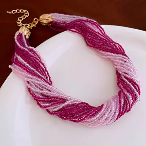 Bohemian multi-layer seed bead necklace in pink and rose red with golden tulip clasp