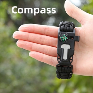 Detail of outdoor survival bracelet with built-in compass held in a palm