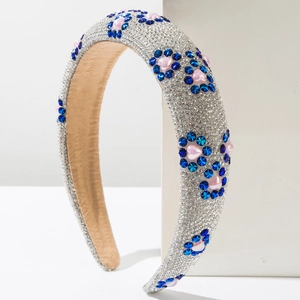 Detail of padded headband featuring silver sequins, blue stars, and pink heart crystals
