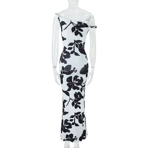 Detail of black and white floral print on a sexy one-shoulder slim fit maxi dress