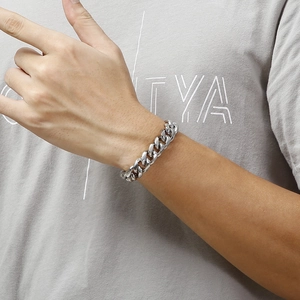 Polished silver titanium steel Cuban link bracelet worn on wrist for a modern jewelry style