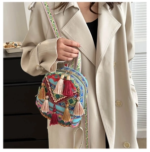 Detail view of ethnic embroidery patterns and tassels on a lightweight women backpack