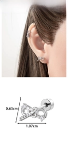 Detailed view of silver bow stud earrings with clear zircon stones and size dimensions