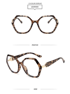 Detail of leopard print TR90 geometric glasses frame with golden V-shaped metal logo
