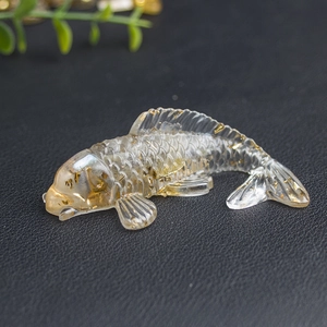 Macro detail of clear resin koi fish sculpture with shimmering gold foil flakes