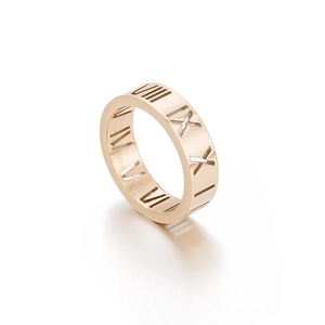Rose gold titanium steel ring featuring hollow Roman numeral cutouts on a white background