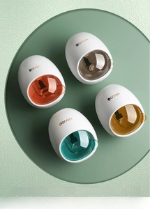 Detail of automatic toothpaste dispensers in four Morandi colors on a display stand
