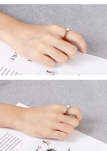 Close-up of rose gold hollow geometric ring featuring white shell pearl inlay