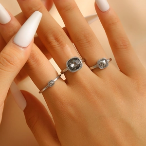 Three-piece silver ring set with square grey acrylic stones in a geometric stackable design