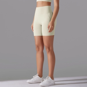 Side view of cream high-waisted yoga shorts with seamless front and ergonomic stitching