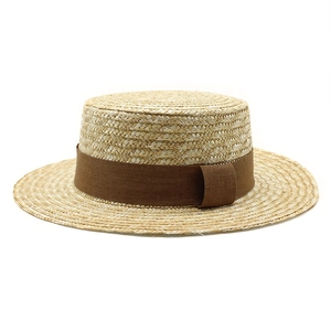 Detailed view of the fine woven texture and dark brown ribbon on this retro straw boater hat