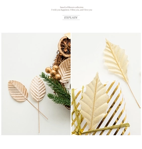 Detail of artificial gold leaves with fabric texture and wire stems for gift box decor