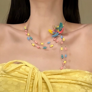 Close-up view of the dopamine style colorful beaded necklace with a sweet flower design.