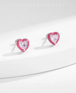 Close-up of heart-shaped s925 silver stud earrings with pink zircon and enamel details