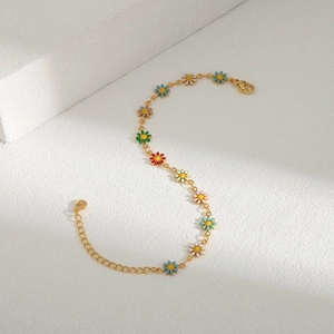 Close-up of golden chain with colorful enamel daisies featuring a secure lobster clasp