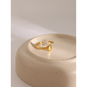 Detailed macro of 18k gold stainless steel open ring with pave heart and polished heart
