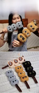 Detail of plush cat balls styled as candied haws in four colors with cute expressions