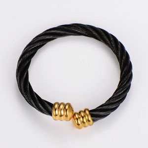 Macro shot of twisted black cable wire texture with elegant gold screw cap ends