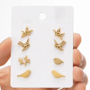 Detailed close-up of 4-pair set golden stainless steel bird and hummingbird stud earrings