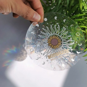 Macro detail of holographic rainbow suncatcher window sticker with sunflower and moon design