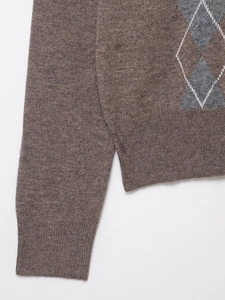 Close-up of wool blend argyle knit pattern and ribbed texture on the brown sweater