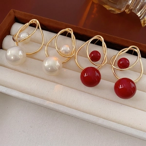 Luxury irregular geometric gold earrings set with pearls and red beads in display box