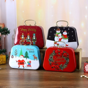 Set of four festive Christmas tin storage boxes with metal handles and holiday designs