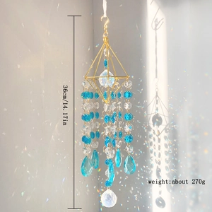 K9 crystal suncatcher with golden frame hanging to create rainbow light spots on wall