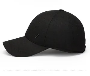 Detailed side view of black wool baseball cap featuring a silver triangular metal logo badge