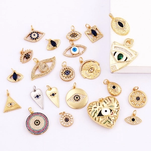 Detail view of Evil Eye amulets in gold and silver finish with zircon and enamel inlays