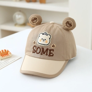 Detail of khaki bear baseball cap featuring plush 3D ears and SOME embroidery