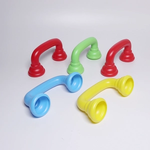 Collection of colorful plastic toy telephone handsets in red, green, blue and yellow