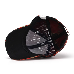 Detail view of the ethnic floral baseball cap interior with adjustable strap and label