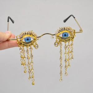 Golden round frame sunglasses with blue evil eye design and diamond tassel details