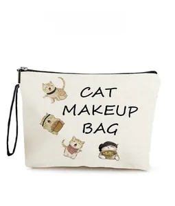Detail of canvas cat makeup bag with cute cat illustrations and a black wrist strap